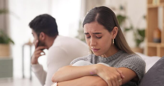 Couple, sad woman and divorce after disagreement or argument on sofa in living room dispute or unhappy relationship at home. Emotional woman and man crying in breakup, cheating or affair from fight