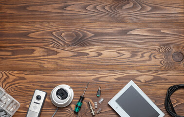 Modern white security cameras and video intercom on the table with space for text. Video surveillance concept background. CCTV Installation concept. Service for installing CCTV cameras.