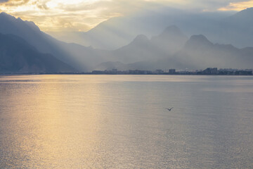 Landscape of Mediterranean sea with mountains in the distance during the sunset, Antalya, Turkey