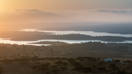 Portugal, Monsaraz, Alentejo. View from the fortress walls to Guadiana river and shores at a foggy dawn