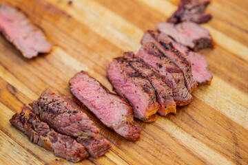 Cut steak pieces on wood cut board