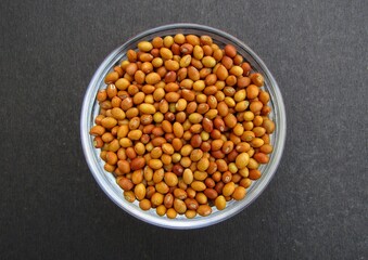 Pigeon pea seeds in a bowl on black background 