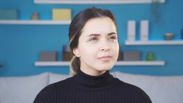 Young woman nodding positively.
Young woman looking at camera shaking her head positively and positively.
