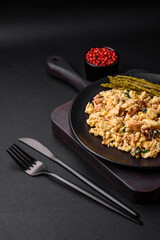 Delicious scramble with salmon, sun-dried tomatoes, spinach, spices and herbs