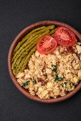 Delicious scramble with salmon, sun-dried tomatoes, spinach, spices and herbs