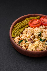 Delicious scramble with salmon, sun-dried tomatoes, spinach, spices and herbs
