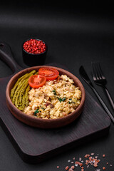 Delicious scramble with salmon, sun-dried tomatoes, spinach, spices and herbs