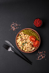 Delicious scramble with salmon, sun-dried tomatoes, spinach, spices and herbs
