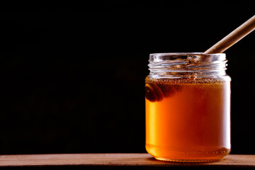 Jar of honey and honey spoon