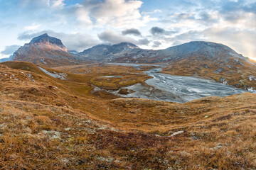 Autumn mountain landscape with peaks in the background