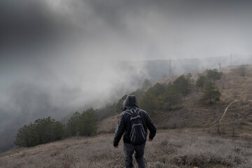 Young man among the nature at foggy weather