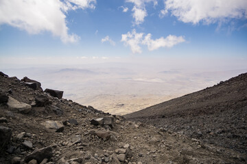 Rocky slope made of stones on Mount Ararat on a sunny summer day with clouds, slopes with scree