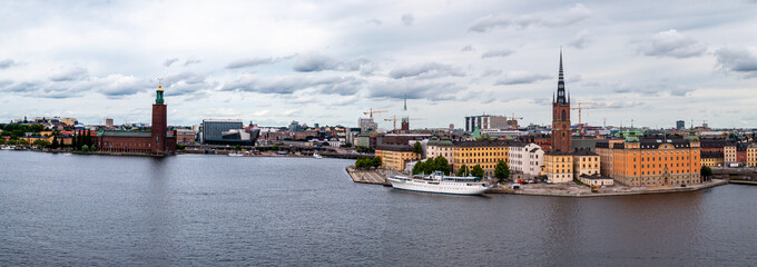 Fototapeta na wymiar Stockholm, Sweden - Panorama of the city center and historic Gamla Stan with church, ship and town hall building.