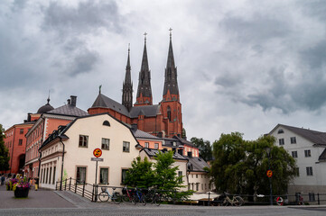 Fototapeta premium Uppsala Cathedral, Sweden - church towers with waterfront and restaurant above the river.