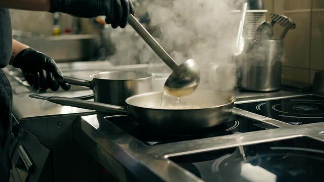 professional kitchen in the hotel restaurant the chef prepares a risotto dish adds ingredients to the pan