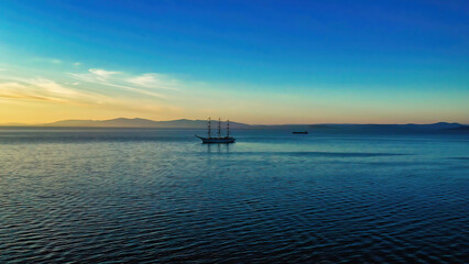 Fototapeta na wymiar Seascape with a view of the sailboat on the horizon