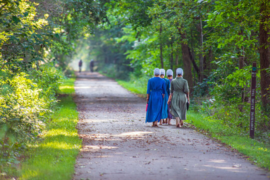 Barefoot Amish girls on a walk on the nature trail.