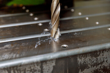 Drilling holes in metal poles for attaching various parts to the poles or connecting the poles to...