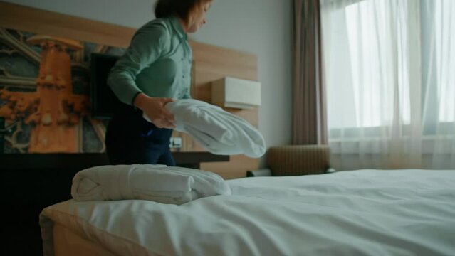 Housekeeping at the hotel the housekeeper brought white robes for guests the concept of hospitality