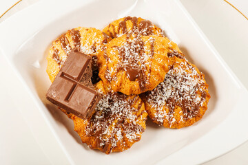 Fresh-baked Snickerdoodle cookies with chocolate and shredded coconut.