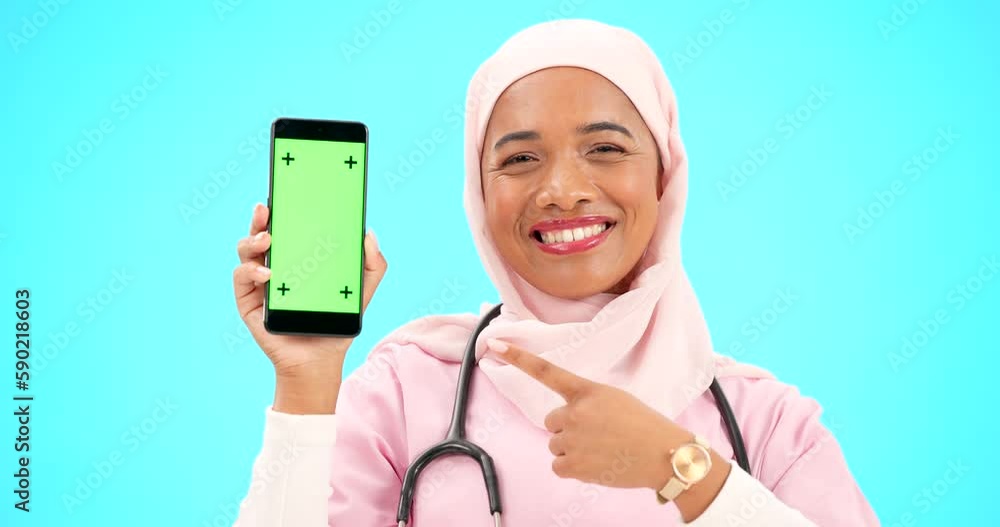 Sticker Green screen, phone and doctor isolated on blue background medical mobile app, tracking marker and mockup. Happy muslim nurse or healthcare woman face, point to cellphone product placement in studio