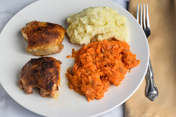 chicken thighs  with mashed carrots and potatoes