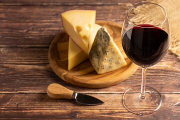 Cheese board with a glass of red wine.