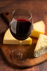 Cheese board with a glass of red wine.