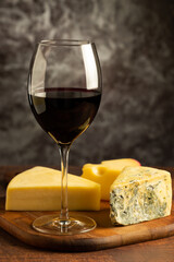 Cheese board with a glass of red wine.