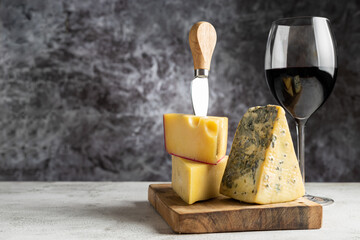 Cheese board with a glass of red wine.