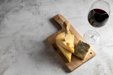Cheese board with a glass of red wine.