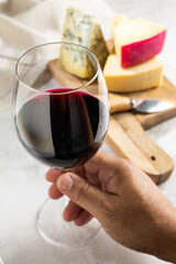 Cheese board with a glass of red wine.