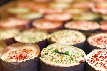 Easter Cakes decorated with white sugar glaze staying in raws. Traditional Easter baking on festive table.Selected focus