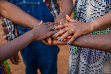 Hands of African people on top of each other, concept of unity.