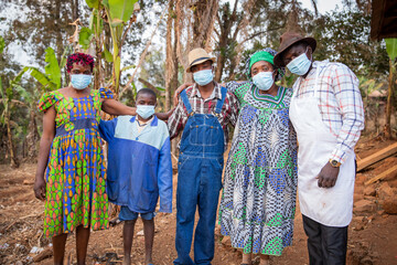 A group of African people in the village wear surgical masks to protect themselves from coronavirus