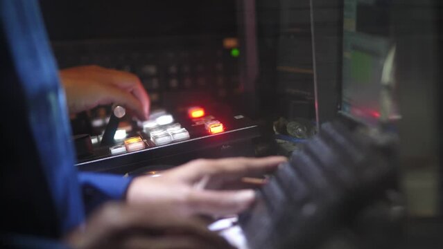 Close-Up Hands Operating Video Switcher in Broadcast Control Room &ndash; Live Production Studio Scene