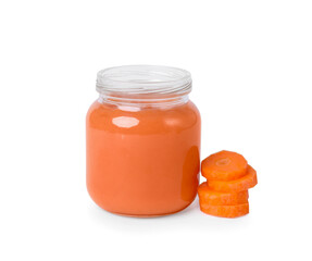 Jar of healthy baby food and carrot slices on white background