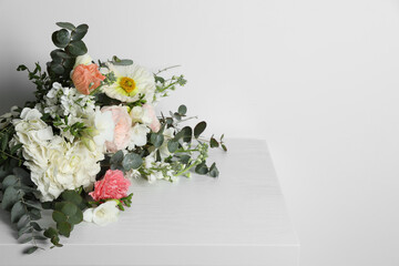 Bouquet of beautiful flowers on white wooden table. Space for text