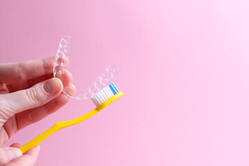 Cleaning plastic aligner aligners with a toothbrush 