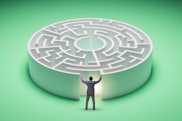 Businessman trying to find a way out of maze