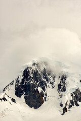 Clouds blowing over mountain peaks on Anvers Island in Antarctica