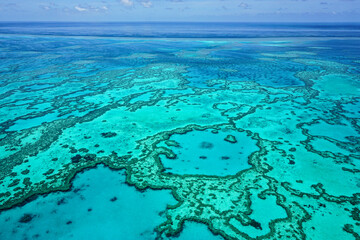 Aerial view of part of the Great Barrier Reef, the world's largest coral reef system composed of...