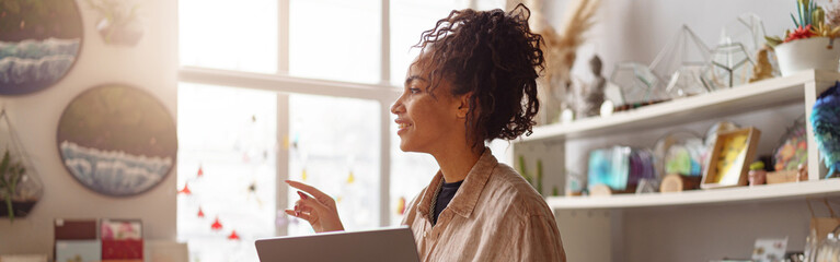 Successful female decorator working online from own art studio and check customers order