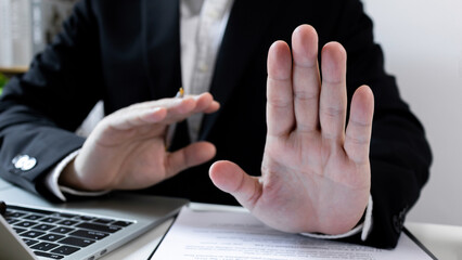 Businessman hand stop sign. refusing to take bribe, anti-corruption laws in action, ban or...
