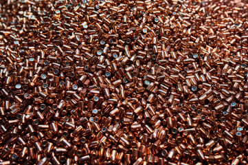 Brass metal bullets pile for weapons as background