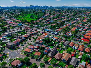 Naklejka premium Panoramic Aerial Drone view of Suburban Sydney housing, roof tops, the streets and the parks NSW Australia