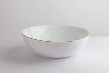 empty ceramic bowl on a white table in a studio lighting 