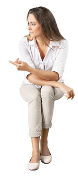 Portrait of a young  pretty woman sitting isolated on background
