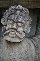 Fototapeta na wymiar Sandstone carvings of Chinese cyclists in Wat Pho, Bangkok, Thailand.