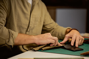 talented successful craftsman makes leather long-lasting,close up side view portrait, the secret of...